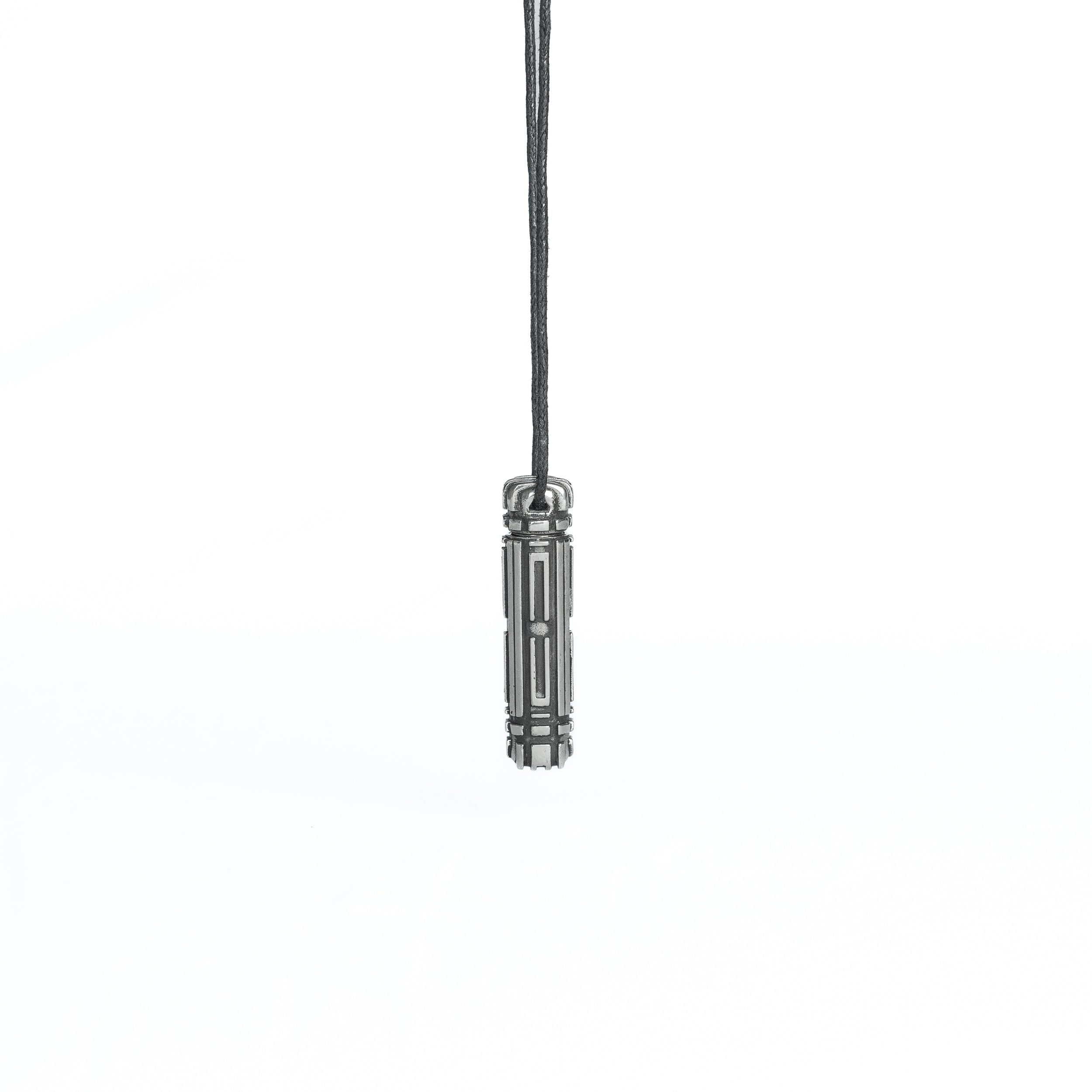 A minimalist futuristic pendant in dark metallic finish, suspended from a black cord. The sleek, geometric design gives it an industrial cyberpunk aesthetic.