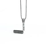 The pendant unscrewed to reveal a hidden inner compartment, emphasizing its functional design and high-tech inspiration.