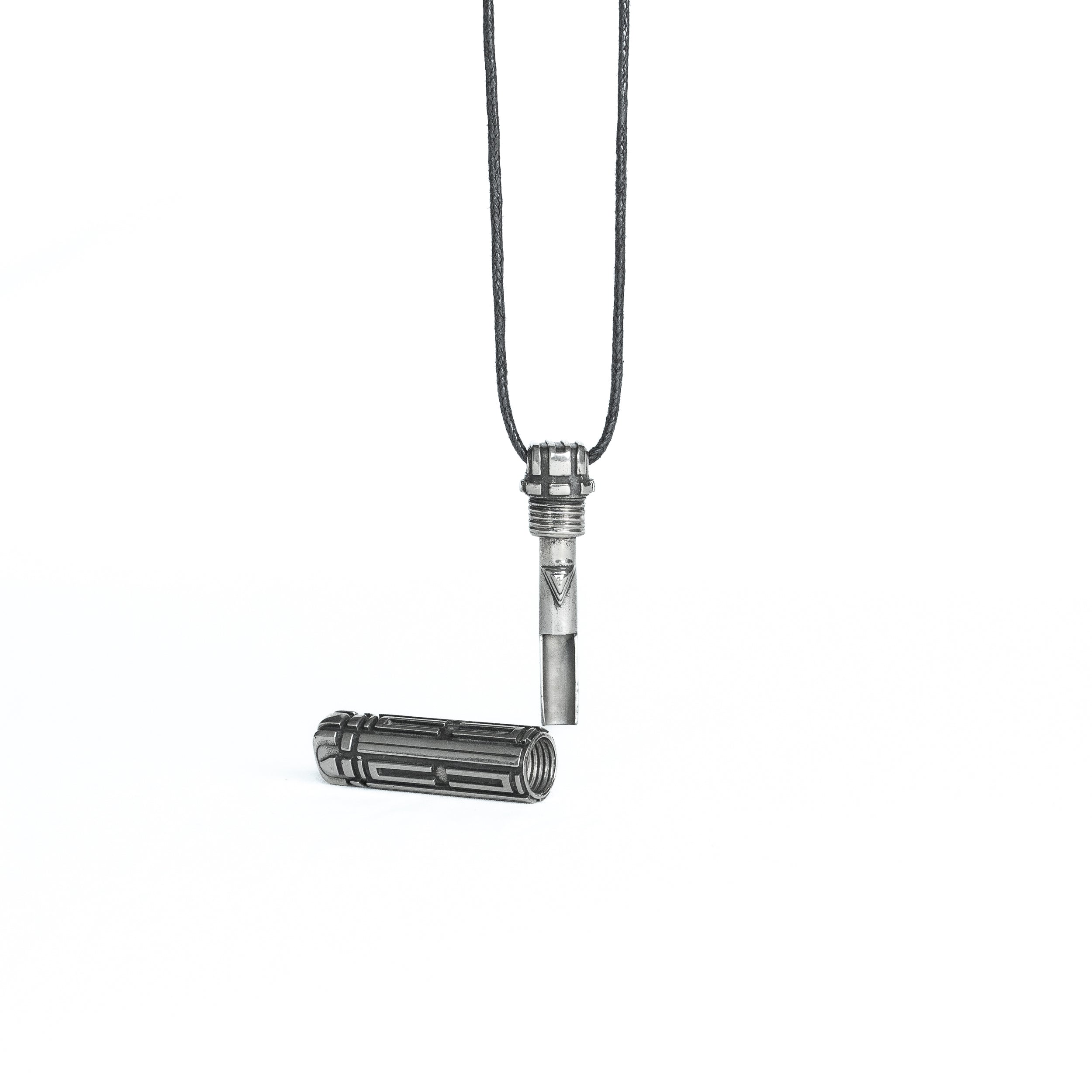 The pendant unscrewed to reveal a hidden inner compartment, emphasizing its functional design and high-tech inspiration.