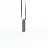 A straight-on view of the pendant hanging from its cord, highlighting the symmetry and mechanical precision of the design.