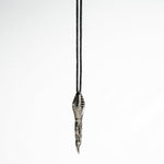 Close-up of the pendant’s tip, revealing the spoon-like scoop with a 6mm by 9mm dimension and surrealist design.
