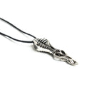 Biomechanical pendant with a ribbed exoskeleton design, inspired by futuristic and gothic aesthetics, suspended on a black cord