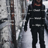 A person with long hair, wearing dark clothing and the VENOM Men's Leather Hooded Vest Jacket by Kaya Movement, walks down an alleyway. Text on the image reads, "How to measure your size: 1. Take a string 2. Wrap around your chest, waist, hips 3. Measure the length of the string." Arrows point to chest, waist, and hips.

