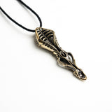 Close-up of the pendant’s tip, revealing the spoon-like scoop with a 6mm by 9mm dimension and surrealist design.