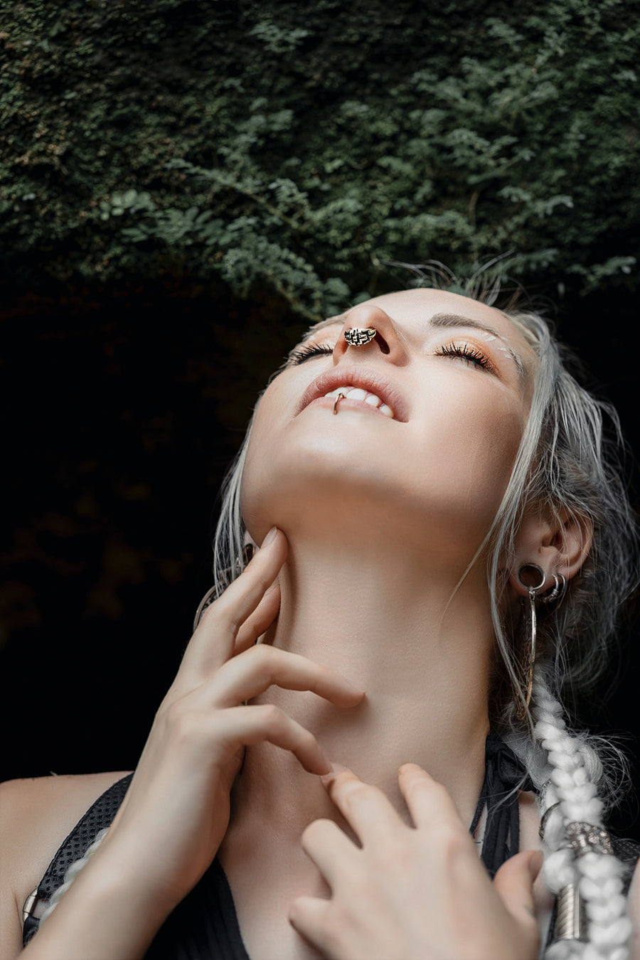 Stylish septum piercing in 925 sterling silver, adorned by a woman with striking silver hair and a modern, bohemian ensemble.