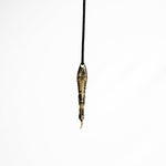 Side view of the brass spoon pendant, displaying the detailed craftsmanship and dark oxidized finish.