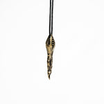 Sleek brass spoon pendant with biomechanical and cyberpunk design elements, hanging from a minimalist black cord.