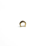 A front-angle view of a brass bio-organic septum ring with a clicker closure, showing its smooth curvature and antique finish.