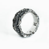 BIOORGA sterling silver biomechanical ring seen at a three-quarter angle, with polished ridges and dark recesses.