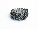 Top angled view of the BIOORGA sterling silver ring, showing its sculpted band and hallmarks.