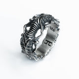 Close three-quarter view of the BIOORGA silver ring and its textured raised details.