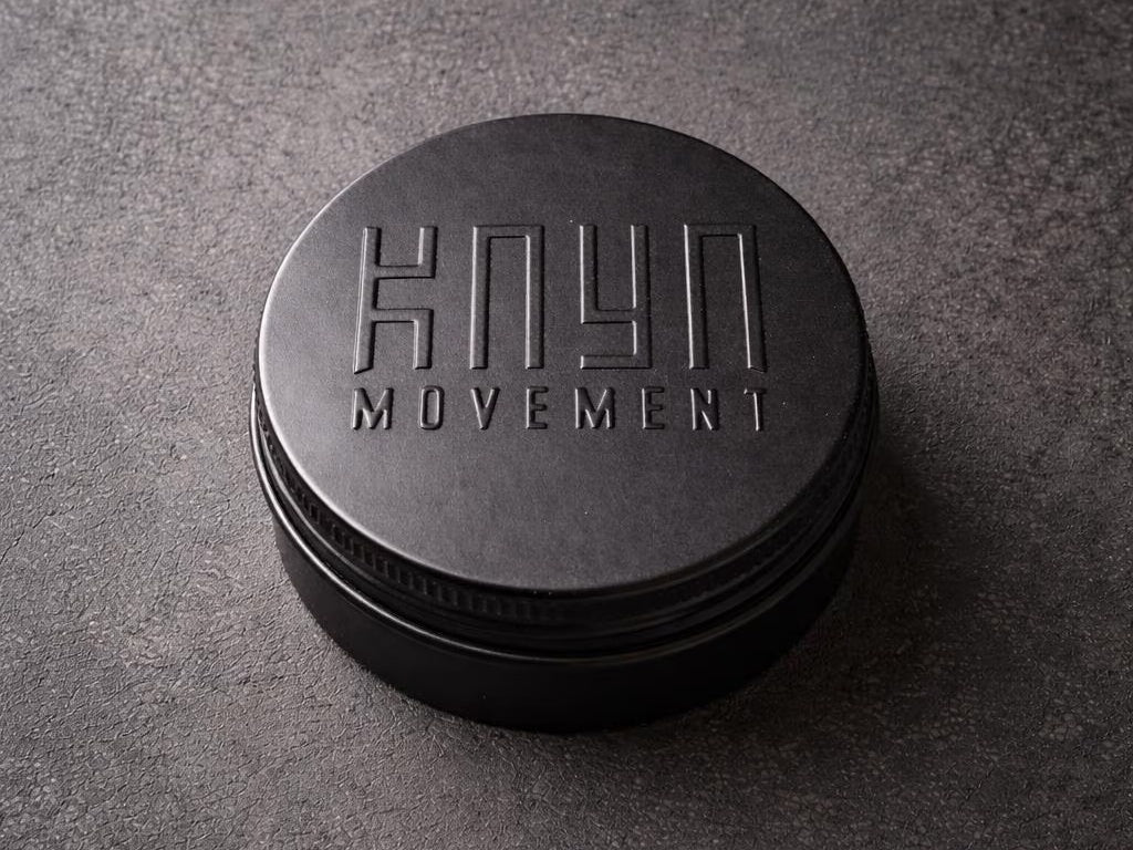Reusable black Kaya Movement metal ring box.