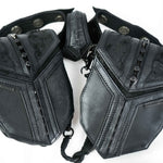 A close-up image of the Kaya Movement KERO Unisex Lightweight Leather Holster Bag, crafted from textured sheep skin leather with multiple compartments and snap buttons. This holster bag features metallic accents, making it an ideal accessory for the Burning Man festival. Two straps extend from the harness, indicating it can be worn around the shoulders.
