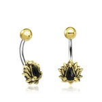 The LIOSA Marquise Belly Piercing Rings in Gold & Onyx by Kaya Movement feature an ornamental floral design. Each elegant navel jewelry piece boasts a black teardrop-shaped stone at the center, encircled by gold petals in a lotus flower pattern. The 14 gauge curved barbell and top ball are crafted from polished surgical steel, making these exquisite belly button rings ideal for gift packaging.
