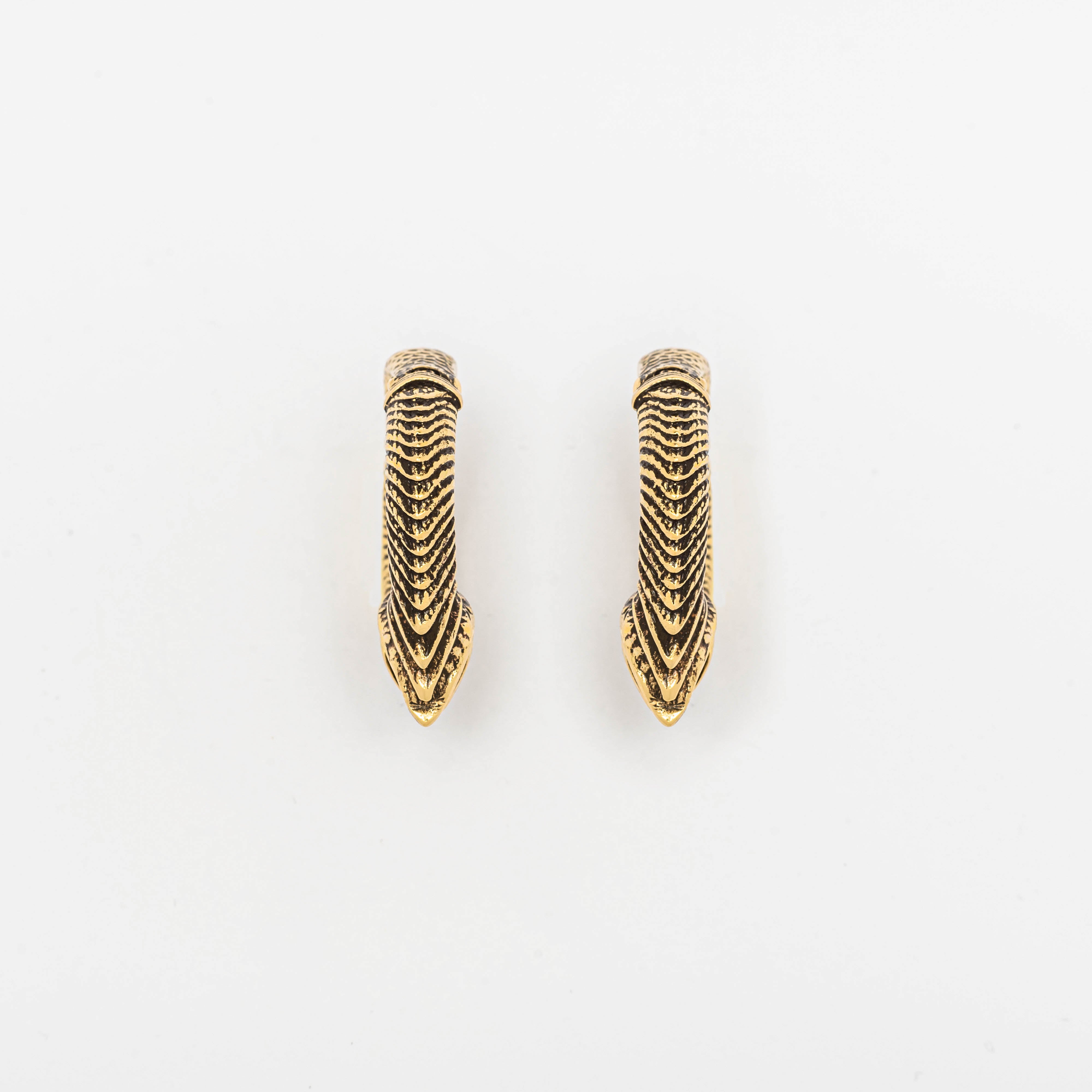 Image of a pair of Kaya Movement's MARVDASHT Small Cyborg Hoop Clicker Ear Weights in Gold, designed in 2 gauge. These sophisticated ear weights feature an intricate, textured design with pointed tips, bridging the gap between post-apocalyptic body jewelry and timeless fashion. Suitable for both formal and casual wear, they offer an elegant appearance perfect for any occasion.
