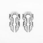 A pair of TECHRE Futuristic Hexagon Keyhole Ear Weights in Silver by Kaya Movement, intricately designed with symmetrical, silver-colored, key-like shapes. Each ear weight features sharp, geometric edges and grooves that lend a futuristic and ornamental appearance evocative of post-apocalyptic body jewelry. The 0 gauge ear weights are identical and positioned side by side on a white background.