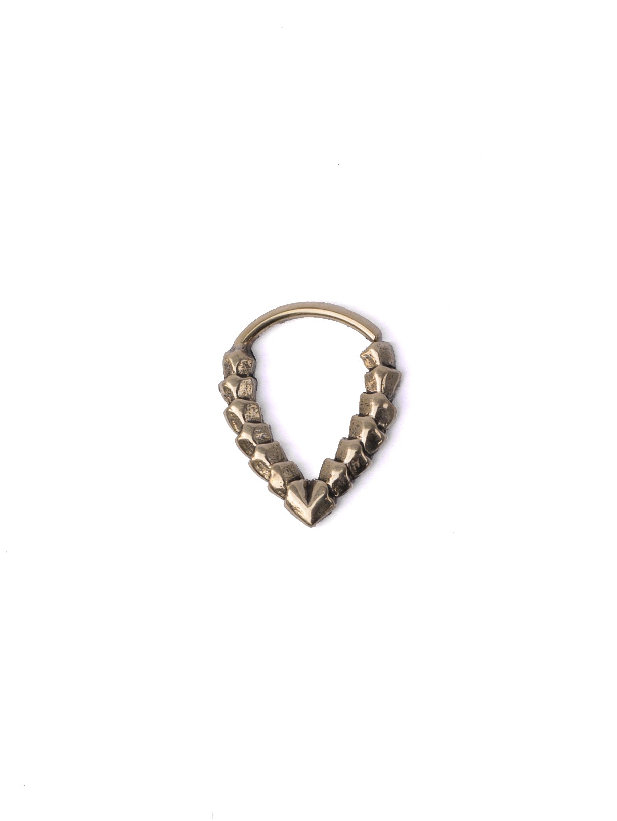 A tarnished KAMO Biomech Teardrop Septum Ring in Gold by Kaya Movement, featuring a rough, jagged texture along its lower arc, resembling an intricately designed piece of gold brass jewelry. The 16-gauge ring is set against a plain, white background.