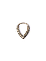 A tarnished KAMO Biomech Teardrop Septum Ring in Gold by Kaya Movement, featuring a rough, jagged texture along its lower arc, resembling an intricately designed piece of gold brass jewelry. The 16-gauge ring is set against a plain, white background.