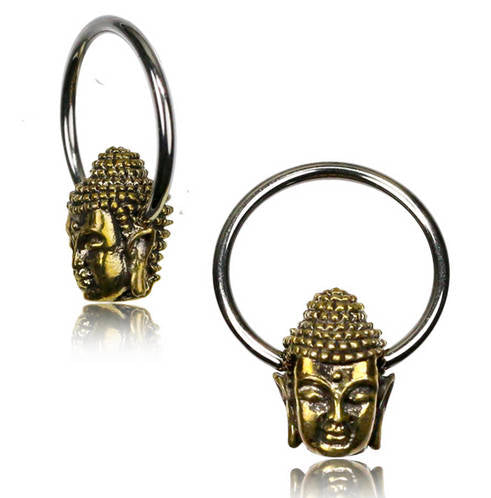 The BUDDHA Silver Rings with Gold Pendants from Kaya Movement showcase two circular jewelry pieces, each adorned with a golden Buddha head pendant. The intricate design features detailed facial features and textured hair. These versatile piercing hoop earrings are displayed from various angles, emphasizing the meticulous craftsmanship of the pendants. Available in 18, 16, or 14 gauge sizes.