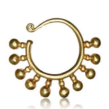 The TILA Ear Hangers in Gold by Kaya Movement are luxurious accessories crafted in a 6 gauge size, featuring an exquisite design inspired by Tribal Borneo aesthetics. Made from yellow brass, these golden ear hangers boast small spherical ornaments dangling along the bottom arc and a slight curl at the top, adding intricate detail to their elegant yet antique look.