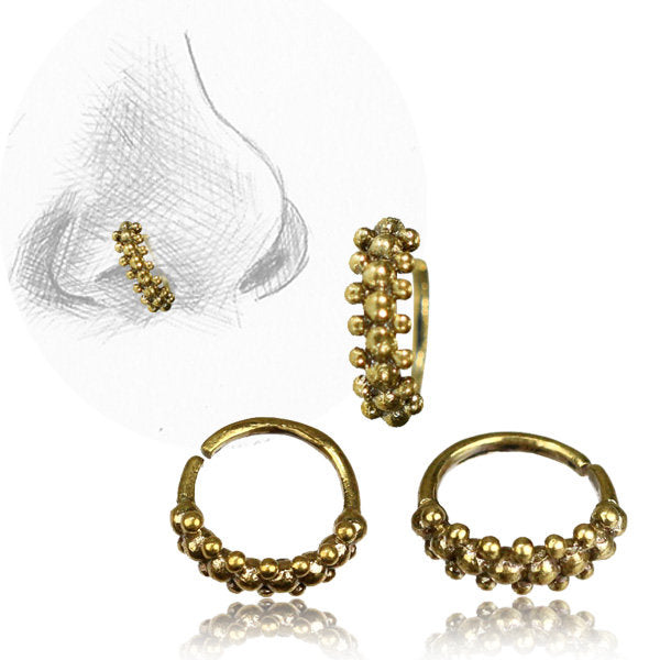 The ROE Beaded Nose Ring in Gold by Kaya Movement is a set of brass body jewelry rings with decorative bead detailing. One image illustrates a nose wearing one of these 20 gauge rings, while three rings are displayed below from different angles, showcasing their intricate beaded tribal ethnic design. The circular rings feature an open end for easy wear.