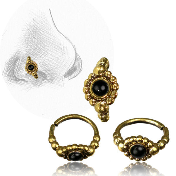 The SHA Beaded Flower Nose Ring in Gold & Black Onyx by Kaya Movement is a stunning set of nose rings featuring a central natural black onyx gemstone surrounded by small, intricate gold beadwork in a beaded tribal ethnic design. One ring is displayed in an illustration of a nose, while two others are shown alongside it from different angles. The rings are 20 gauge in size.