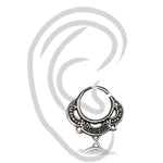 The MANDA Mandala Septum Ring in Silver by Kaya Movement, available in 20 or 18 gauge, is showcased against a white background. The intricate tribal ethnic mandala designs on the 925 silver jewelry exhibit detailed circular and triangular patterns. A faint grey outline of an ear is subtly visible behind the septum ring.