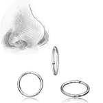 A sketch of a nose with a nose ring in the nostril is shown in the upper left corner. Three INDUS Seamless Minimalist Hoop Rings in Silver by Kaya Movement, crafted from 925 silver body jewelry and designed at 20 gauge, are displayed against a plain white background. These rings feature a minimalistic design, come in various sizes, and are perfect for multi-use piercing.