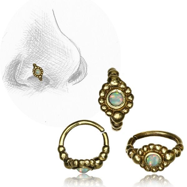 A gold nose ring, specifically the SHA Beaded Flower Nose Ring in Gold & Black Onyx (20 gauge) by Kaya Movement, is shown in three different angles: one straight on, one angled, and one partially open. The image also includes a pencil sketch of a nose with the multi-use piercing hoop earring placed on it.