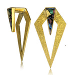 The DIA Minimalist Triangle Ear Hangers in Gold & Abalone Shell by Kaya Movement are crafted from gold-toned metal, featuring a sophisticated triangular design. Each ear hanger showcases a larger textured gold triangle and a smaller smooth triangle adorned with a vibrant, marbled abalone shell inlay at the top. This exquisite 0 gauge body jewelry adds elegance to any outfit.