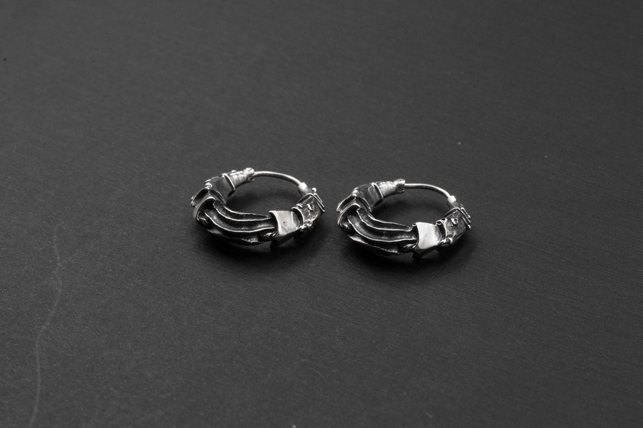 Bio Organic Silver Hoop Earrings from Kaya Movement, featuring intricate designs and a dark, tarnished finish that perfectly captures the cyberpunk aesthetic, showcased on a black background.