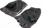 The DZALA Black Genuine Leather Fingerless Gloves by Kaya Movement feature bold red accents and studded knuckles. Despite some fraying and thinly worn areas indicating prior use, these motorcycle gloves retain their rugged appeal. Displayed flat on a white surface, their worn character only adds to their charm.