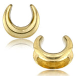 The Minimalist Horseshoe Saddle Tunnels in Gold by Kaya Movement are displayed against a white background. Each tunnel features a smooth, shiny surface and an open semi-circle design. They are arranged such that one is reflected below the other.