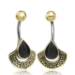 The IKOSA Fan Belly Piercing in Gold & Black Mother of Pearl by Kaya Movement is a pair of 14-gauge gold-colored surgical steel curved barbell earrings. These earrings feature gold balls on one end, with the other end adorned with intricate, fan-shaped designs and Black Mother of Pearl teardrop inlays, combining metallic and black tones for a unique and stylish appearance.