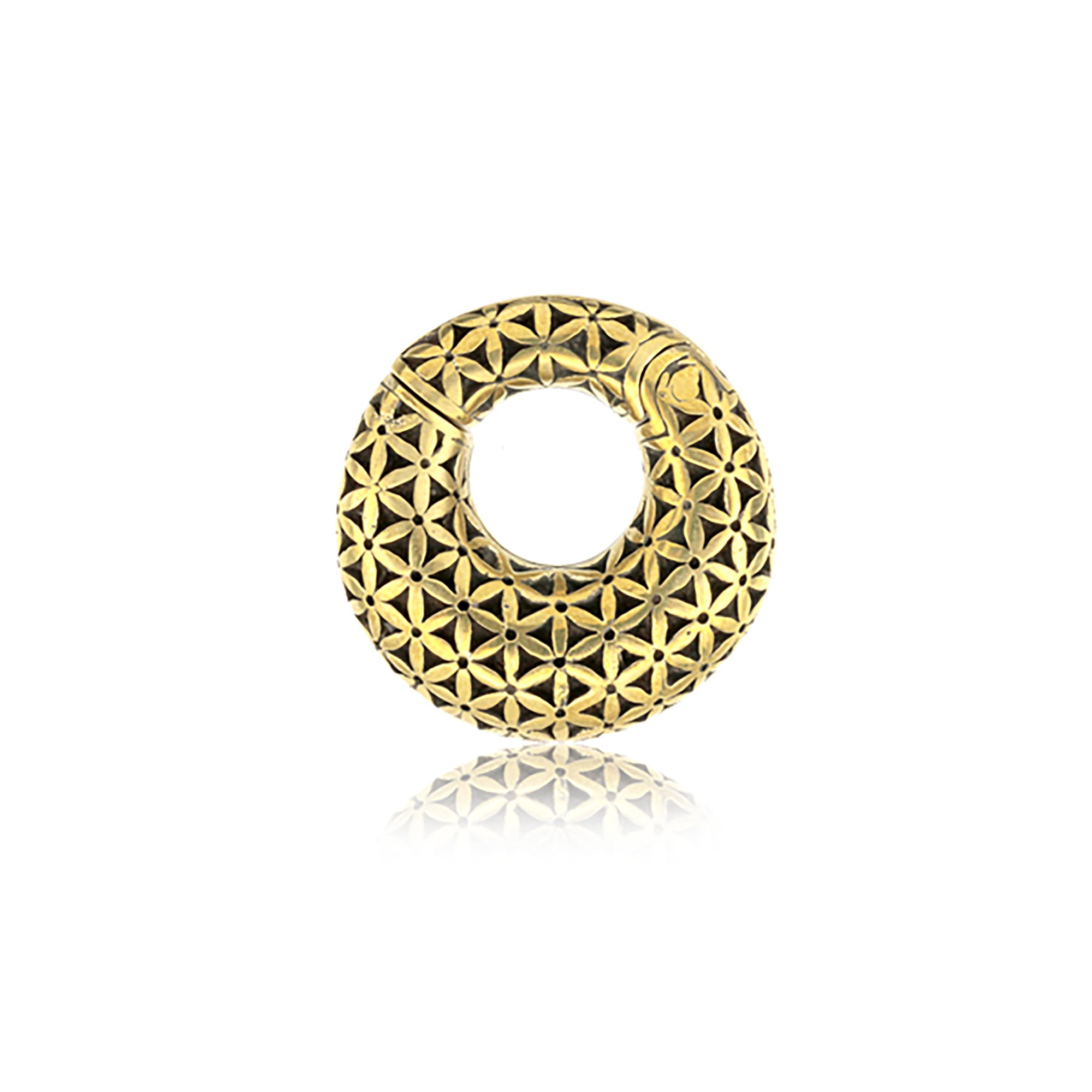 The FLOWER OF LIFE Hoop Ear Weights in Gold with Clicker from Kaya Movement showcase an intricately designed, reflective surface featuring a flower of life pattern made up of interlocking geometric shapes. These elegant 2 gauge ear weights have a hollow center, resembling a donut-like pendant, and are displayed against a white background.
