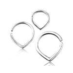 Three varying sizes of the TIKA Simple Teardrop Seamless Rings in Silver by Kaya Movement are positioned on a white background. Each 16 gauge ring, crafted from 925 silver body jewelry, features a smooth, polished finish with a small gap for easy adjustments and wear. The minimalist design is sleek and suitable for multiple piercing applications.