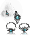 Introducing the Kaya Movement's SHA Beaded Flower Nose Ring in Silver & Turquoise | 20 gauge, a stunning set featuring a black and silver nose ring and nose pin adorned with turquoise gemstone accents. The large nose ring boasts a central circular turquoise stone, encircled by intricate beading, complemented by a smaller, similarly designed pin crafted from 925 silver body jewelry.