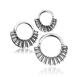 A trio of 925 silver body jewelry earrings from Kaya Movement, featuring an ornate, tribal boho design akin to the AZTEC Septum Ring in Silver. These 16-gauge hoops are arranged with two smaller ones at the top and one larger at the bottom, all reflecting a subtle shine against a white background.