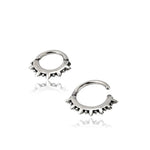 A pair of tiny hoop earrings from Kaya Movement's SPIKE collection, featuring a punk spike design crafted in 16 gauge 925 silver. The hoops are partially open, with evenly distributed spikes along the outer edge, giving them a stylish and edgy appearance. Displayed against a plain white background.