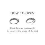 An instructional image shows two rings. The first SKULL Gothic Septum Ring in Gold by Kaya Movement is closed, while the second ring has a wire end bent slightly open horizontally. Text above reads "HOW TO OPEN," and below it says, "Twist the wire horizontally to preserve the shape of your 18 gauge gold brass jewelry.
