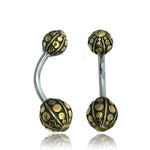 Introducing the GEO Globe Belly Piercing Ring by Kaya Movement, available in gold or silver. This elegant 14-gauge navel piercing features ornate drop-shaped ends, with intricate patterns of raised dots and lines that evoke an antique charm. The sleek surgical steel barbell provides a striking contrast, enhancing the overall look of this exquisite piece. Each ring comes beautifully packaged in an elegant gift box.