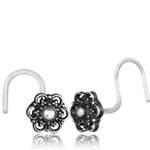 The Kaya Movement Flower Nose Studs, also referred to as Indian Mandala Silver Nose Studs, feature an exquisite pair of silver-toned rings adorned with intricate floral designs. Each stud boasts a central gemstone and ornate detailing with looped and dotted patterns, offering a vintage and elegant look. Crafted from high-quality Silver 925 for added sophistication, these 20-gauge nose studs truly stand out in style.