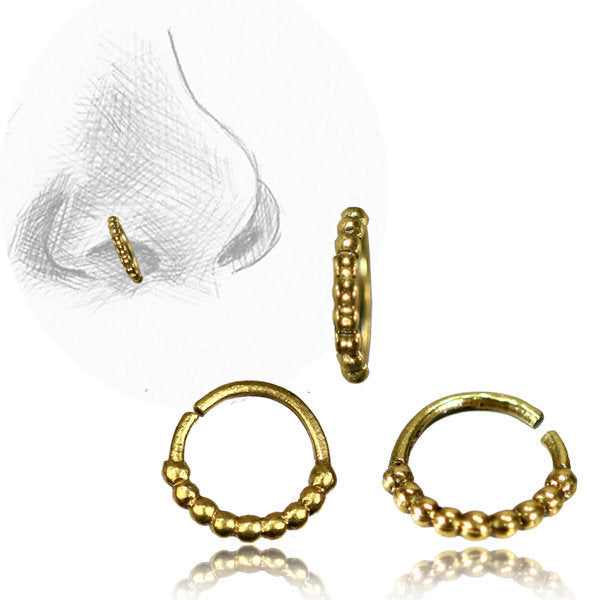 An illustration of a nose adorned with the SOA Single Beaded Ring in Gold from Kaya Movement, featuring a gold beaded nose ring. Beneath the illustration are three close-up images of this 20-gauge gold brass body jewelry, showcasing its design from different angles. The ring features a series of small, round beads.