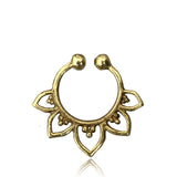 The MAWAR Lotus Fake Septum Ring in Gold by Kaya Movement features an open circular shape with decorative petal-like elements extending from the bottom half. The central area is adorned with small beads, creating an intricate and elegant look against a plain white background.