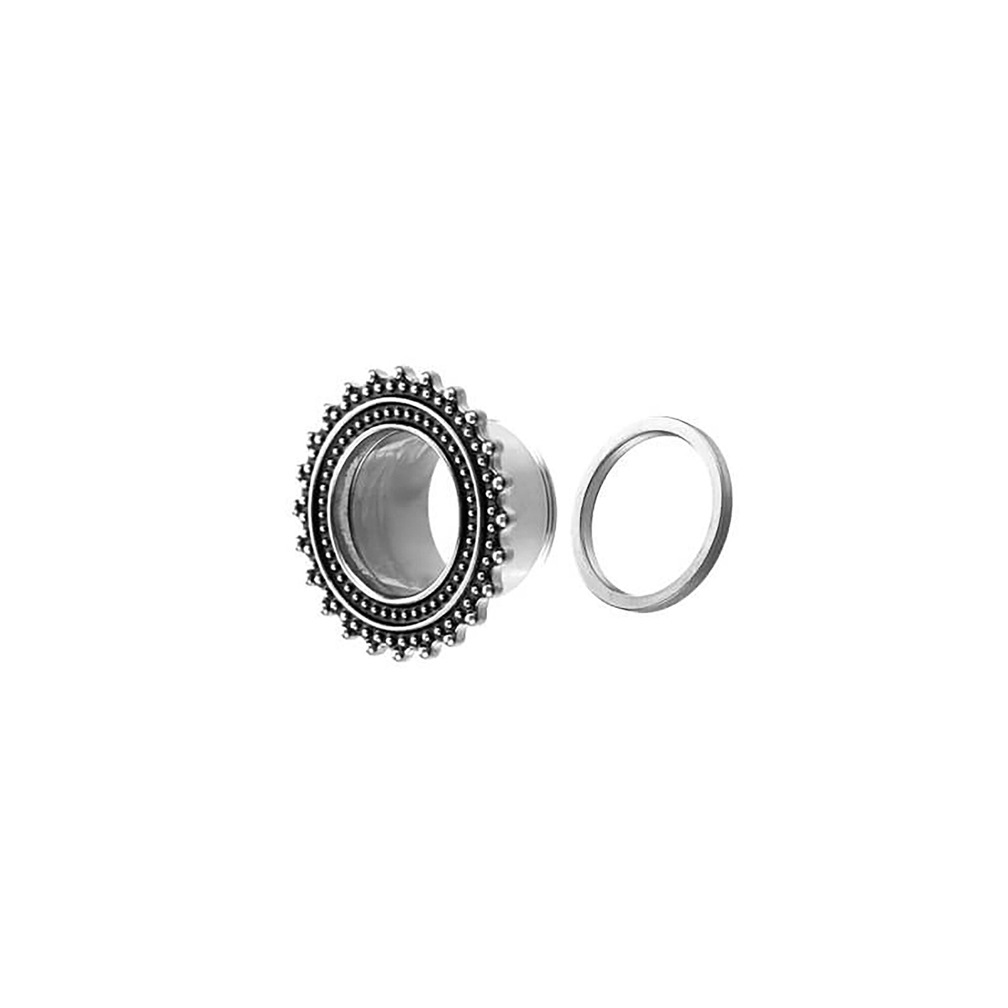 A pair of ear gauges from Kaya Movement, featuring stainless steel plugs with intricate beaded details and a hollow center, evoking an ornate and tribal look similar to traditional stretched ear tunnels. Accompanying these are silver ear tunnels that provide a sleek and minimalist contrast. Both pieces are showcased against a white background.