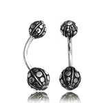 Two Kaya Movement Cute Curved Barbell Banana Belly Button Piercings featuring intricate, spherical end pieces with a design of raised dots and a textured surface. This Tribal Silver Stomach Navel Ring Jewelry's metallic finish provides a shiny appearance, highlighting the detailed craftsmanship. Made from Surgical Steel 316L, each bar measures 8mm in length.