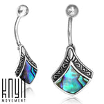Close-up image of two Kaya Movement sterling silver Belly Button Bar Shell Piercings, featuring intricate metalwork and blue-green abalone shell inlays. The Kaya Movement logo is visible in the lower-left corner, showcasing their exquisite 14g navel piercing designs with a short 9mm bar.