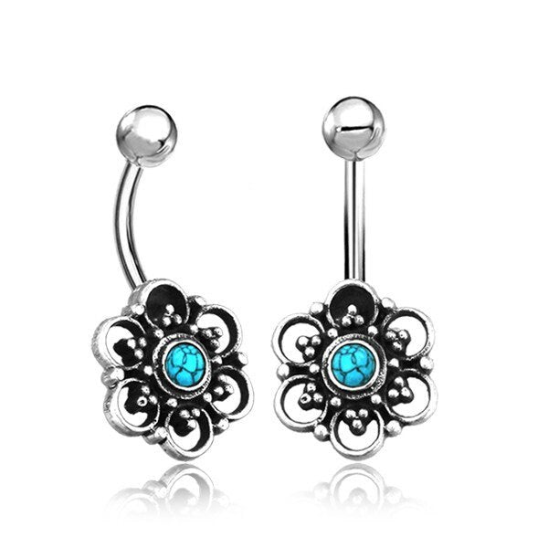 These Kaya Movement Turquoise Belly Rings are the epitome of elegance, featuring curved barbells with intricate lotus flower and mandala designs. Each ring boasts a small turquoise stone in the center, surrounded by delicate filigree detailing, making them perfect for any navel piercing.