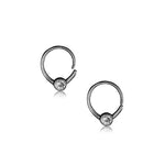 Introducing the Zircon Silver septum ring from Kaya Movement, a minimalist and seamless piece designed as a small horseshoe piercing with an 8mm diameter. Each open-ended ring features a round, clear Crystal Zircon at the center, connecting both ends elegantly. Perfect as body jewelry, this 18g septum piercing is displayed against a white background.