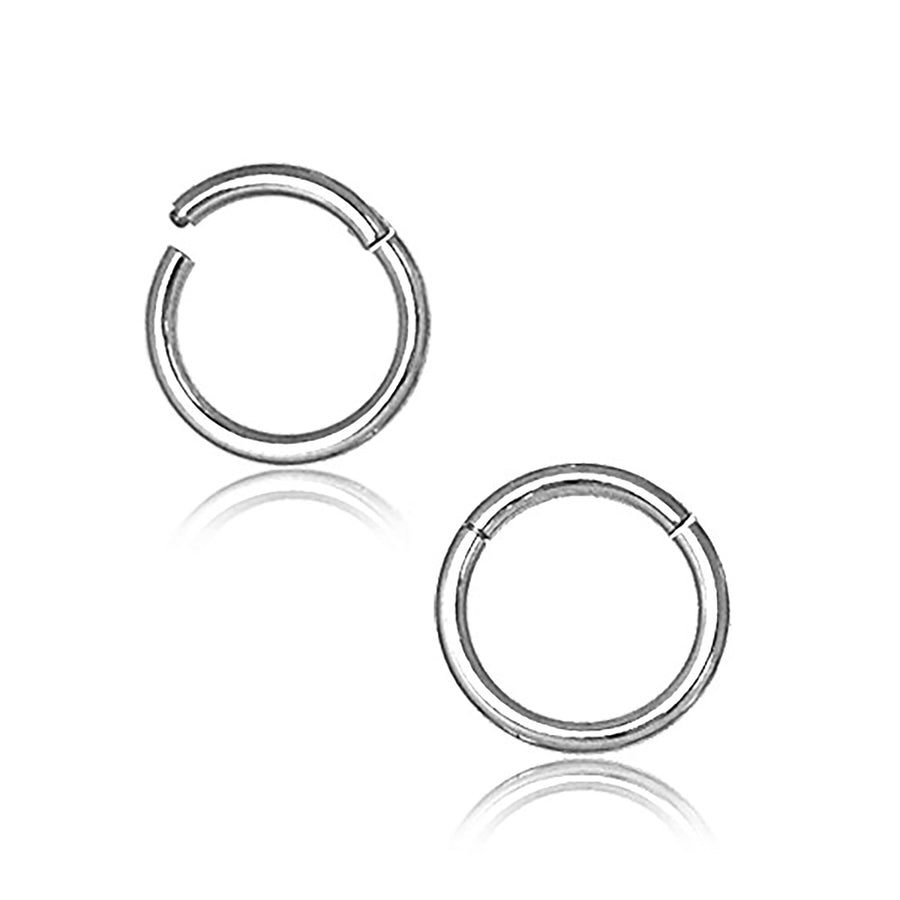 A pair of Kaya Movement's Silver septum clicker rings, crafted from 316L surgical steel, each featuring a polished finish and a small gap. Displayed against a white background, these versatile pieces are designed for various piercings such as daith, rook, helix, and cartilage. The tiny hoops are oriented to mirror each other perfectly.